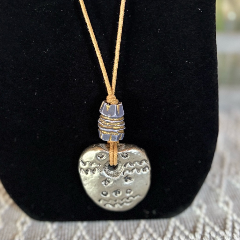 Blue, silver and gold toned hammered design pendant necklace with‎ leather cord.